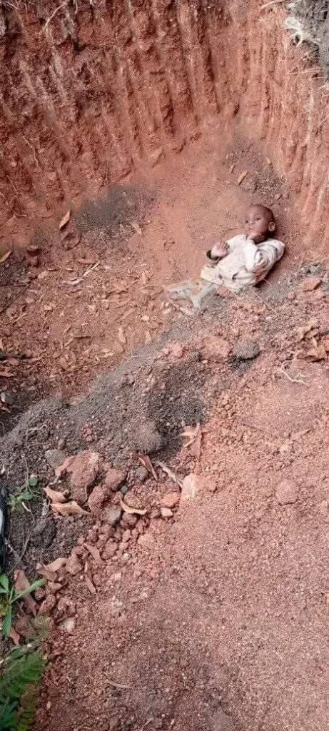 3-year-old Nkosingiphile Ntiwane lying inside the pit where he was found in Masoyi after being missing for nearly a week