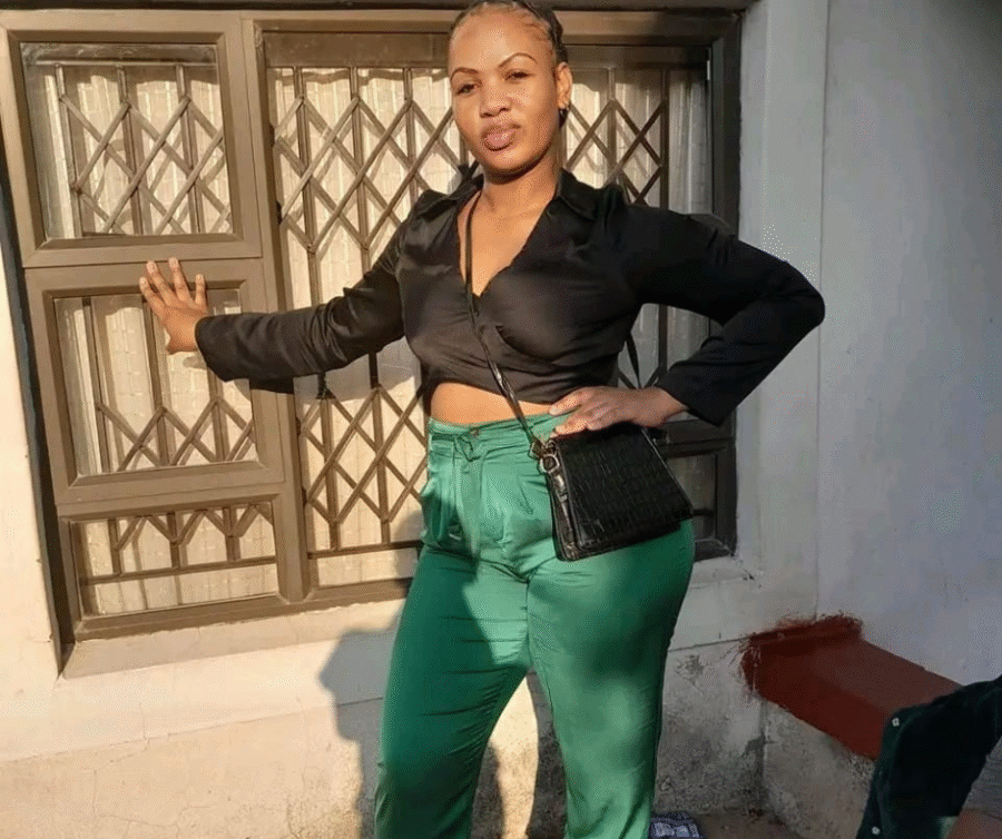 ZamaNguni Gumede Found Dead in Durban Flat 2 ZamaNguni Gumede wearing green trousers and a black top, standing by a wall.